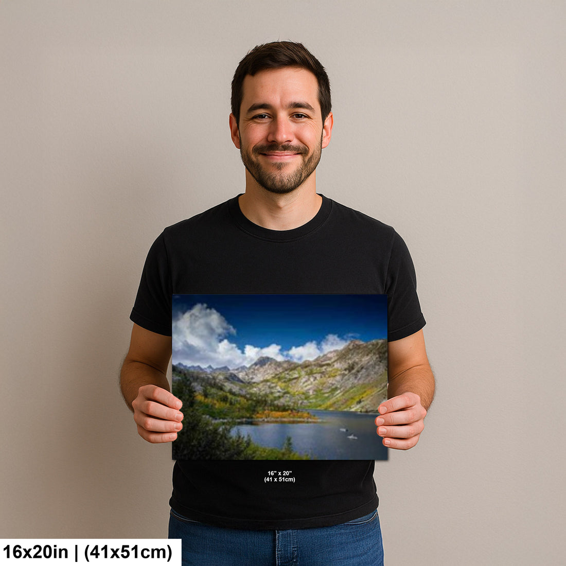 Photographer holding 16x20 inch Eastern Sierra alpine lake print on neutral background.