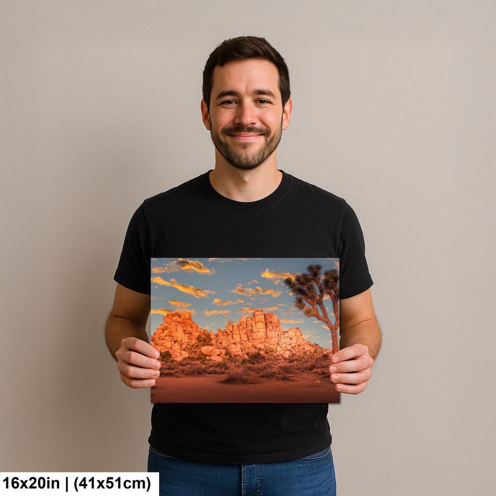 Photographer holding 16x20 inch Joshua Tree golden hour sunset print on neutral background.