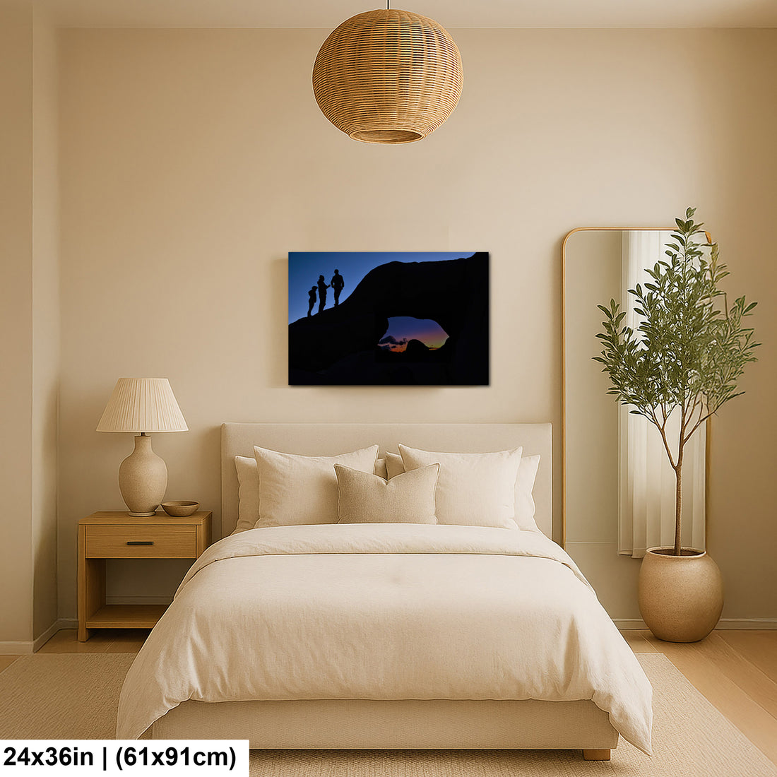 Silhouette of Arch Rock with silhoutte of people on top in Joshua Tree National Park