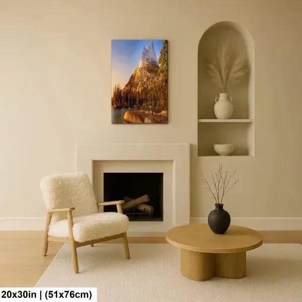 Cozy living room with a soft chair and round coffee table, featuring a mountain landscape print above the fireplace, accented with minimal decor.