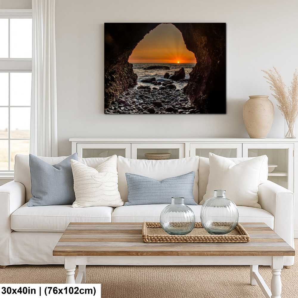 Alpine mountain stream and meadow landscape canvas above white sofa in coastal farmhouse living room.