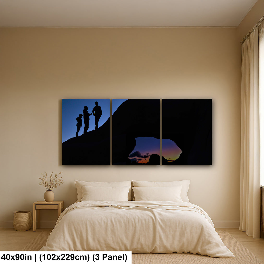 Silhouette of Arch Rock with silhoutte of people on top in Joshua Tree National Park