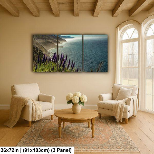 Three-panel coastal landscape artwork hanging above a cozy seating area, featuring a vibrant purple flower field and a view of the ocean and coastline under bright sky.