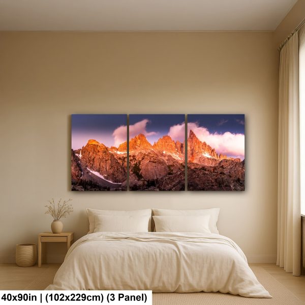 Scenic mountain landscape displayed as a triptych on the wall above a bed in a cozy bedroom with natural lighting.